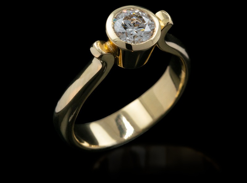 Bezel set diamond solitaire engagement ring in 18ct yellow gold by Rudolf Heltzel
