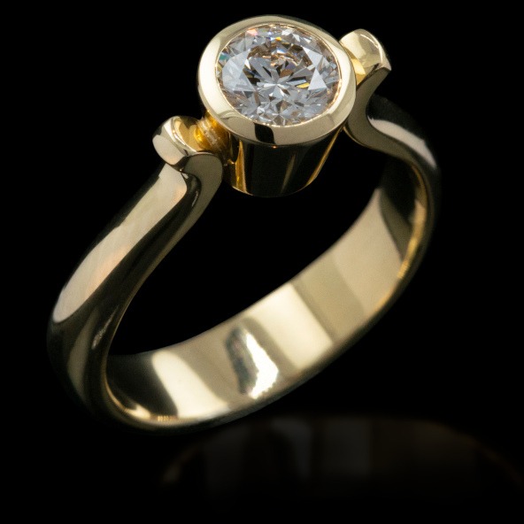 Bezel set diamond solitaire engagement ring in 18ct yellow gold by Rudolf Heltzel