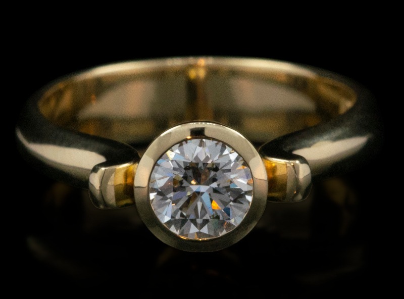 18ct yellow gold solitaire engagement ring with bezel set diamond by Rudolf Heltzel