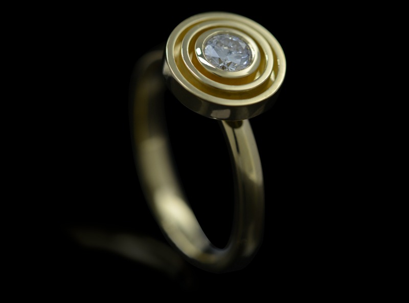 Rudolf Heltzel Handcrafted solitaire diamond engagement ring with double surround in 18ct yellow gold