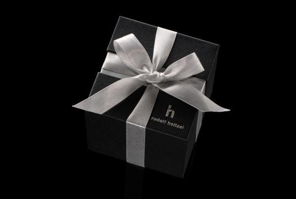 Black and gold Rudolf Heltzel jewellery box with ribbon