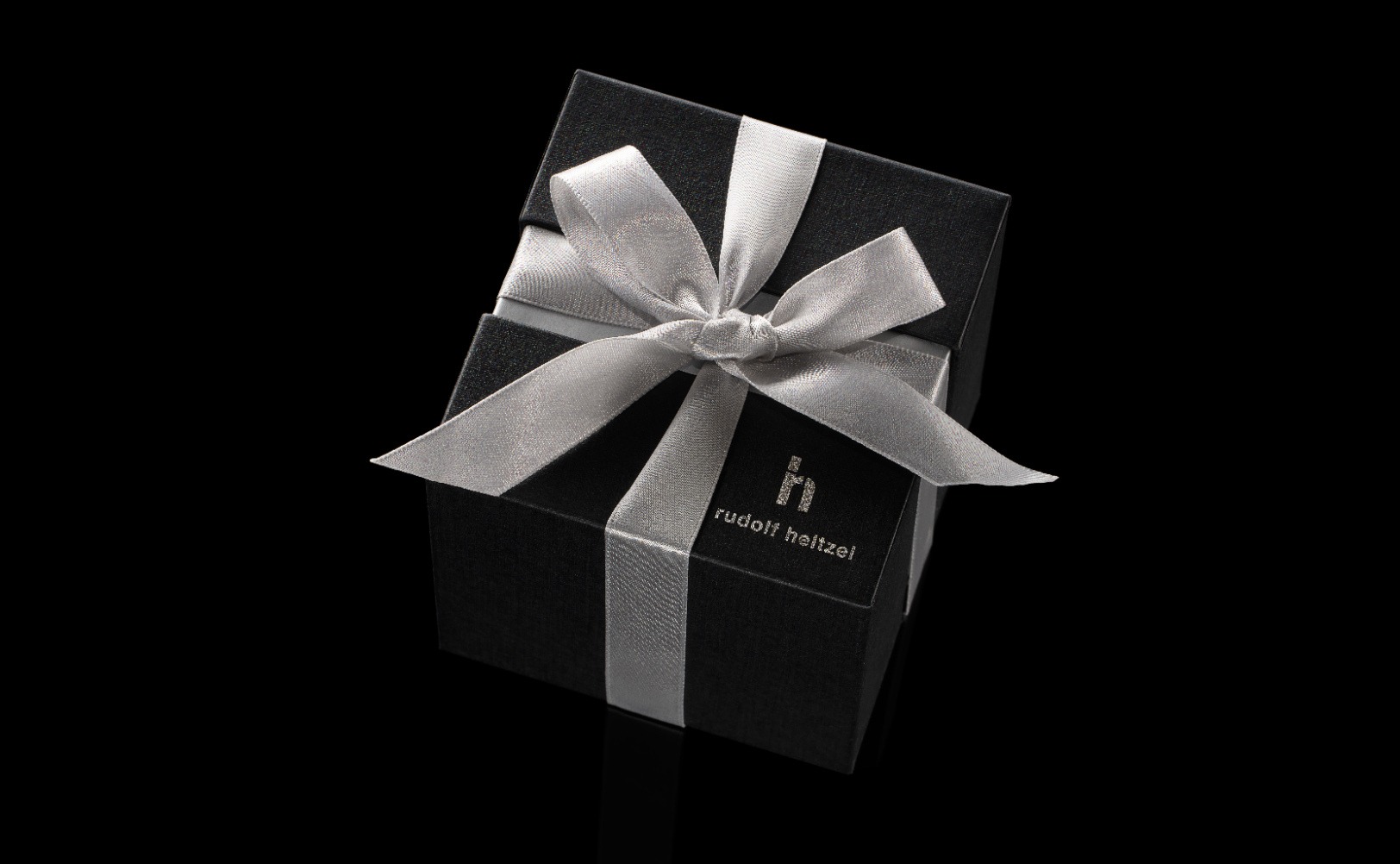 Black and gold Rudolf Heltzel jewellery box with ribbon