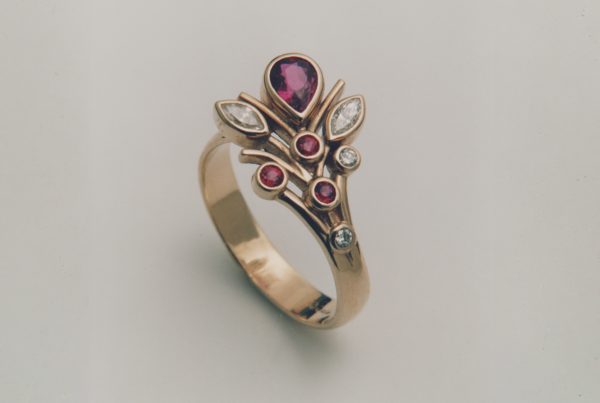 Handcrafted Rudolf Heltzel 18ct yellow gold engagement ring bezel set with garnet and diamonds
