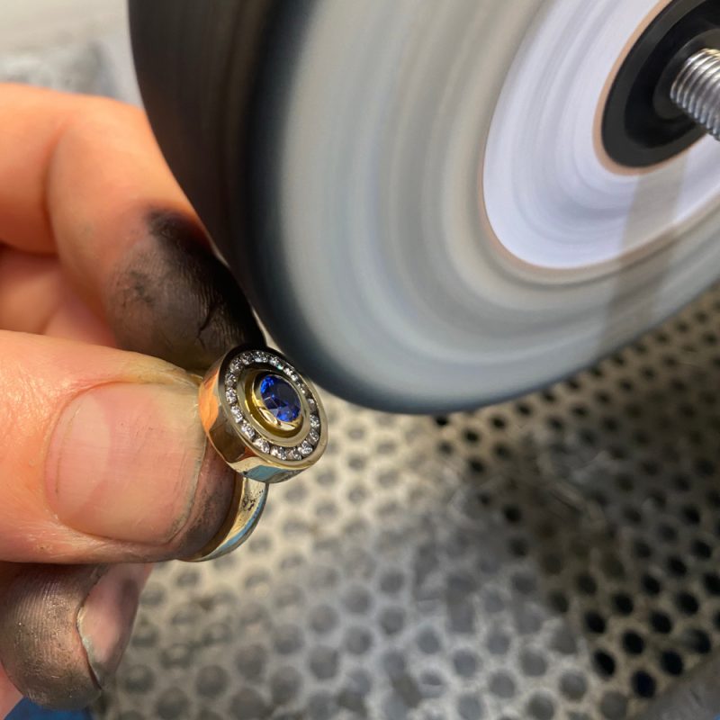 Rudolf Heltzel Sapphire and Diamond Halo Engagement Ring Being Polished