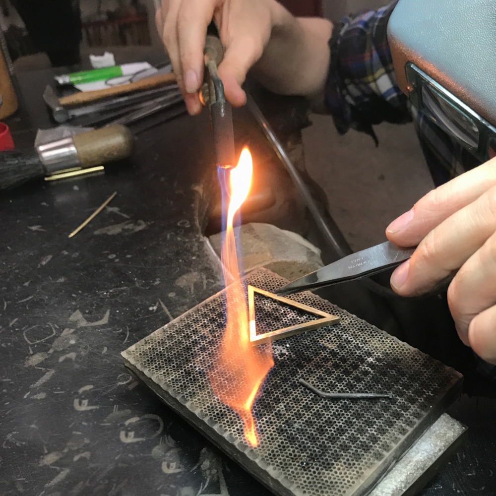 A 18ct yellow gold pendant being handcrafted in Rudolf Heltzel's workshop in Kilkenny City