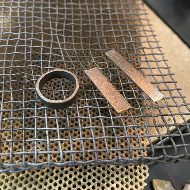 Three Rudolf Heltzel wedding bands being handcrafted